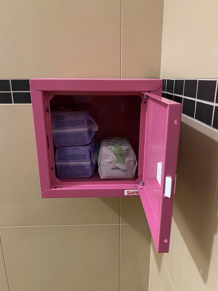 a pink box with personal hygiene products inside