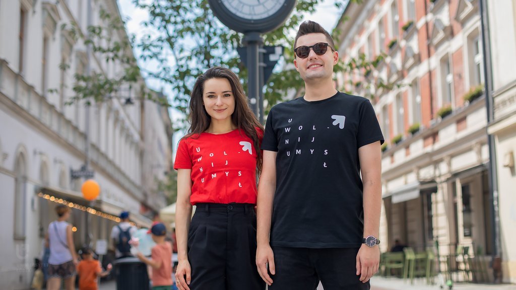 Two students of the University of Lodz (a girl and a boy) standing on Piotrkowska Street in Lodz