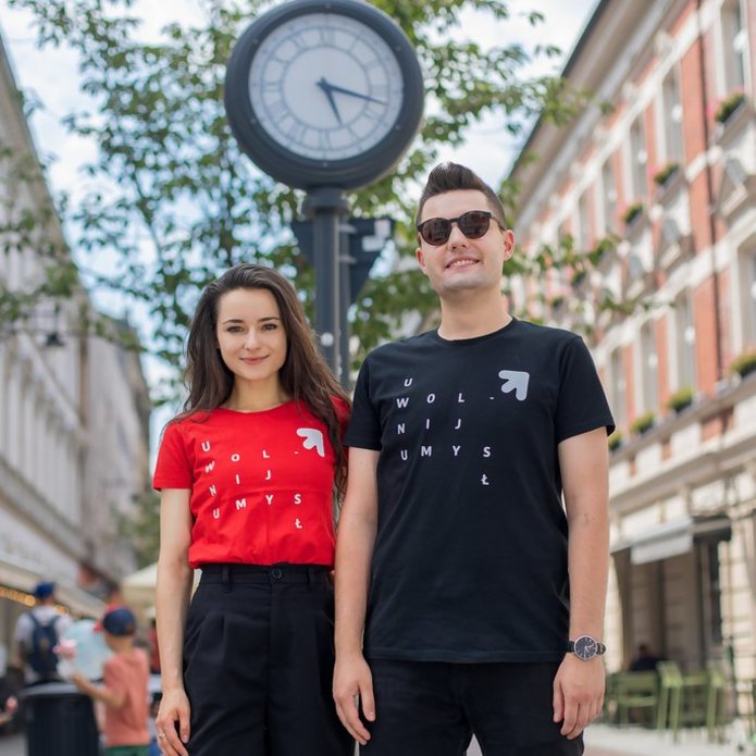 Two students of the University of Lodz (a girl and a boy) standing on Piotrkowska Street in Lodz