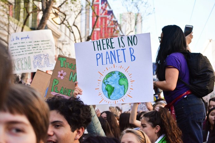 young people protesting and holding a poster "There is no planet B", photo by Li-An Lim on Unsplash 