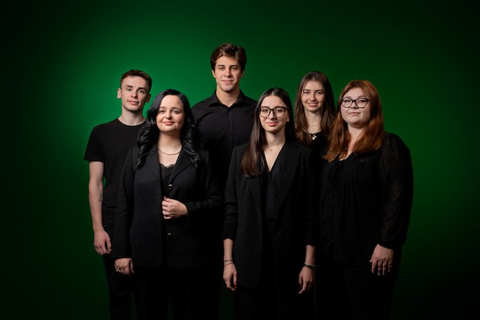 A group of 3 male and 3 female students of the University of Lodz dressed in black